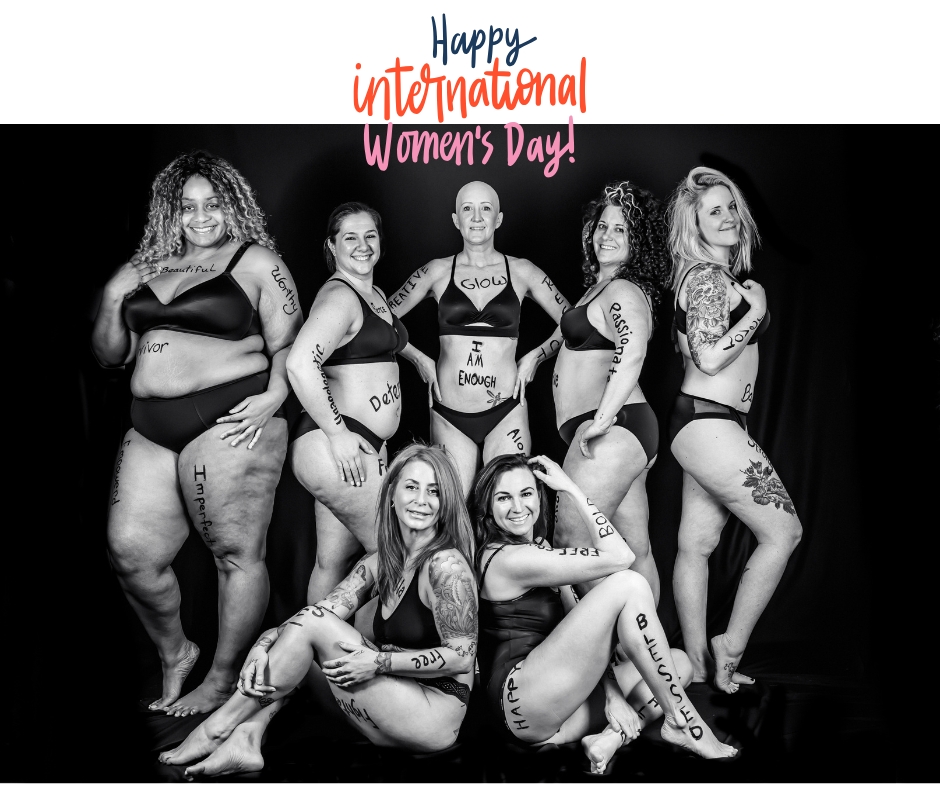 Group of women wearing black underwear and words of affirmation written on their bodies while posing for an authentic and raw photoshoot without editing