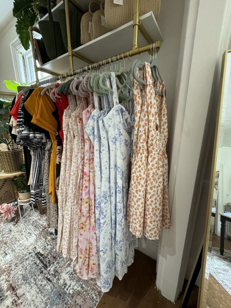 Dresses hanging on a rack for sale at Healing Villa Co.